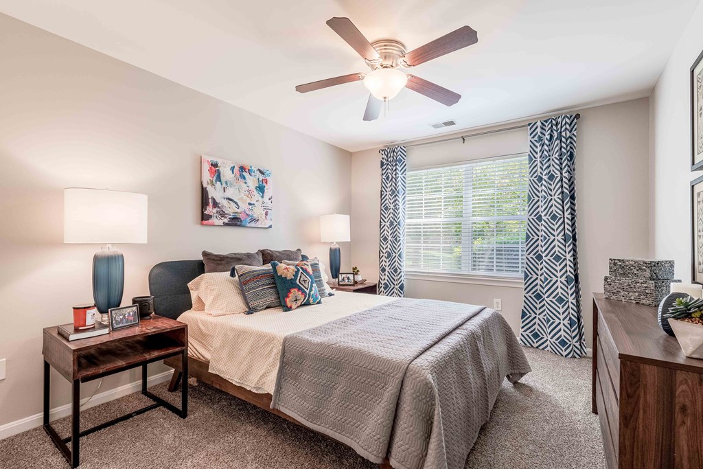 a bedroom with a bed and a ceiling fan