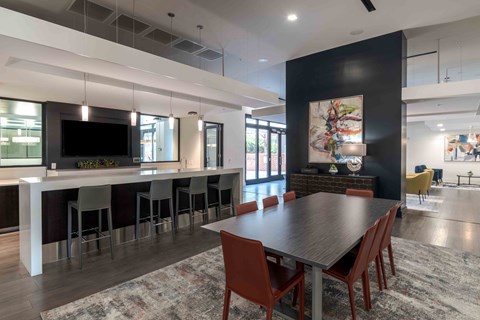 a dining room and kitchen with a table and chairs
