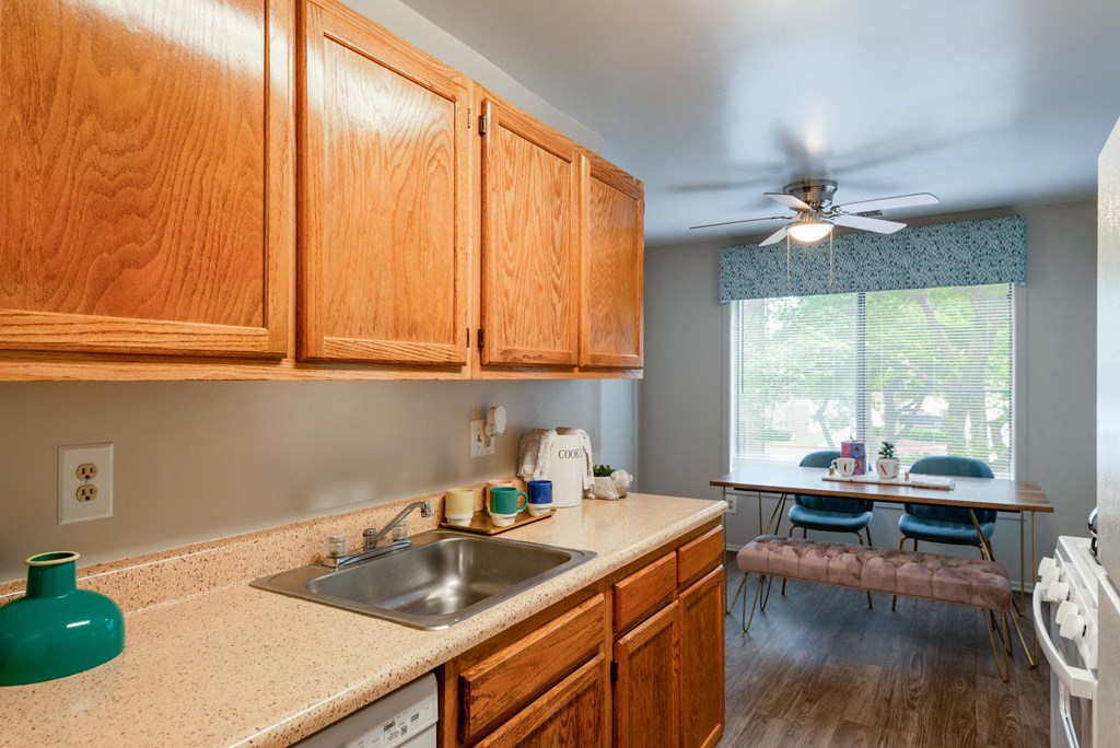 a kitchen with wooden cabinets and a sink and a window