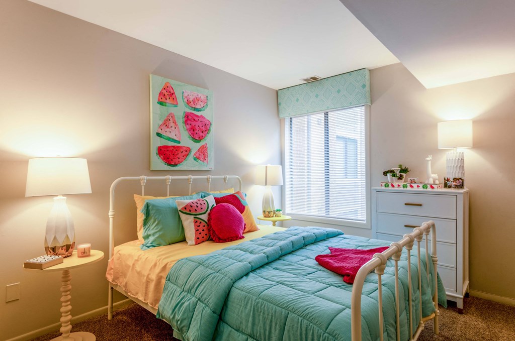 a kids bedroom with a bed and a window