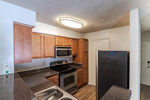 a kitchen with stainless steel appliances and wooden cabinets