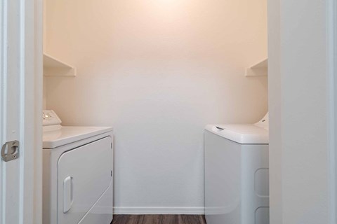 A small laundry room with a washer and dryer.