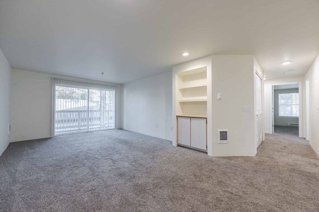 A spacious room living room with a built in bookshelf