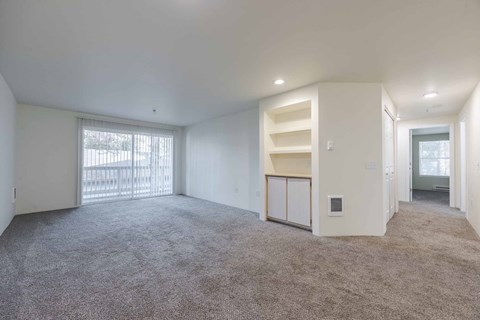 A spacious room living room with a built in bookshelf