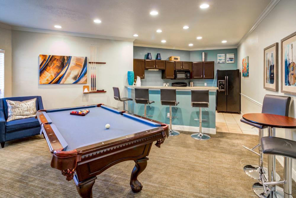 a game room with a pool table and a bar
