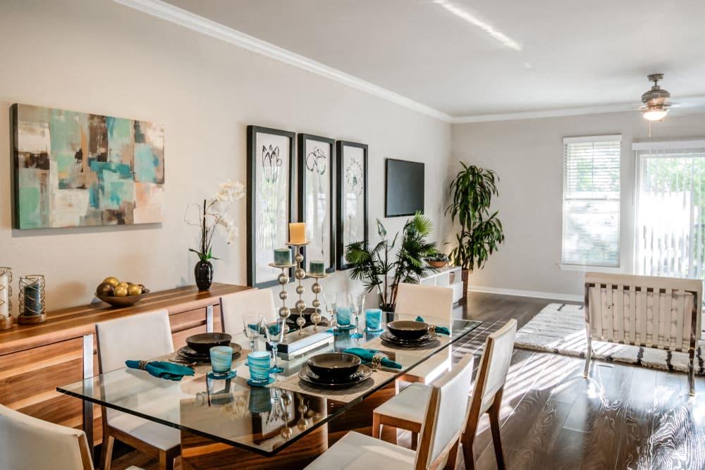 a dining room with a glass table and chairs