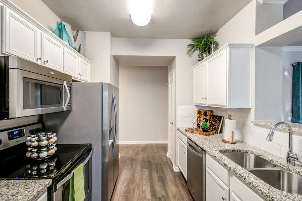 a kitchen with stainless steel appliances and white cabinets