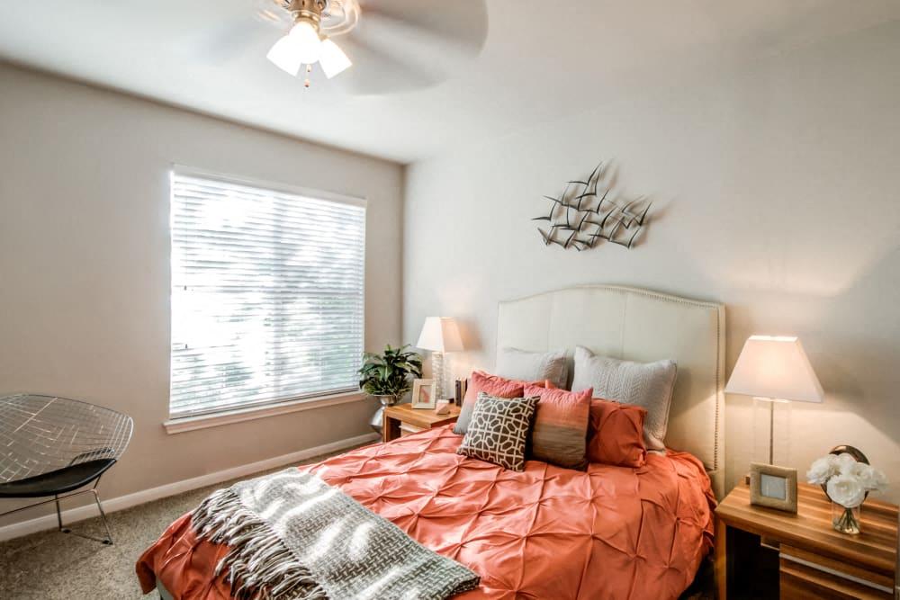 a bedroom with a bed and a ceiling fan