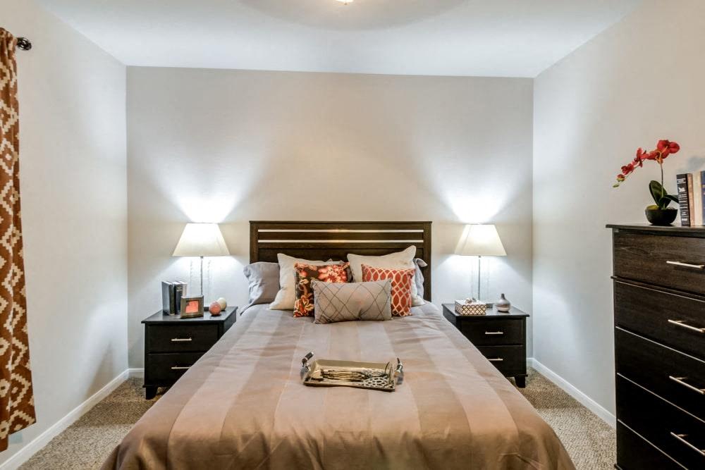 a bedroom with a bed and two night stands