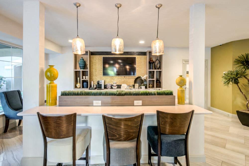 a kitchen with a bar and chairs