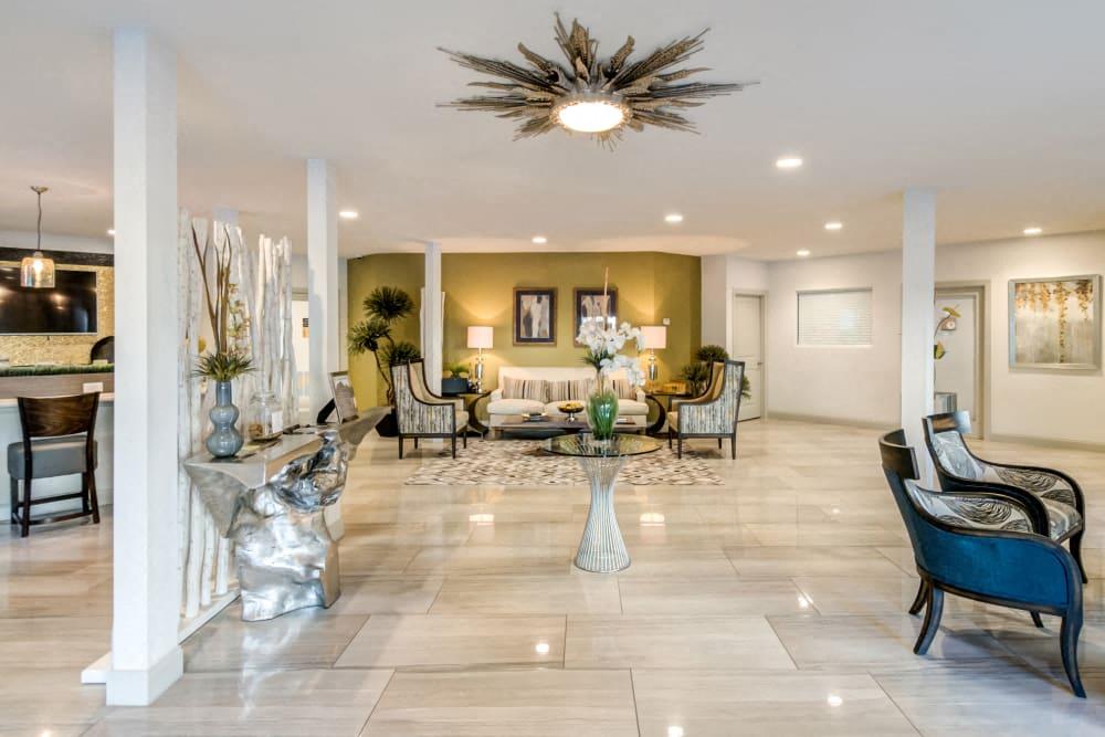 a large living room with a table and chairs