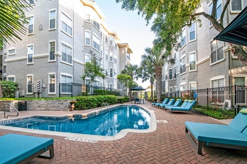 a swimming pool in front of an apartment building
