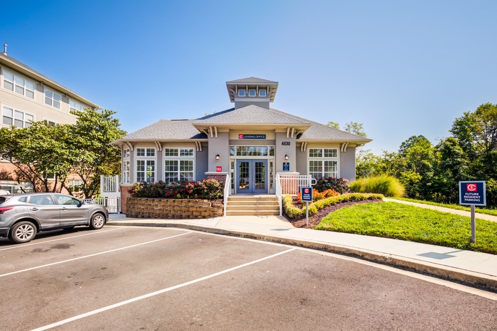 a building with a parking lot and a car parked in front of it