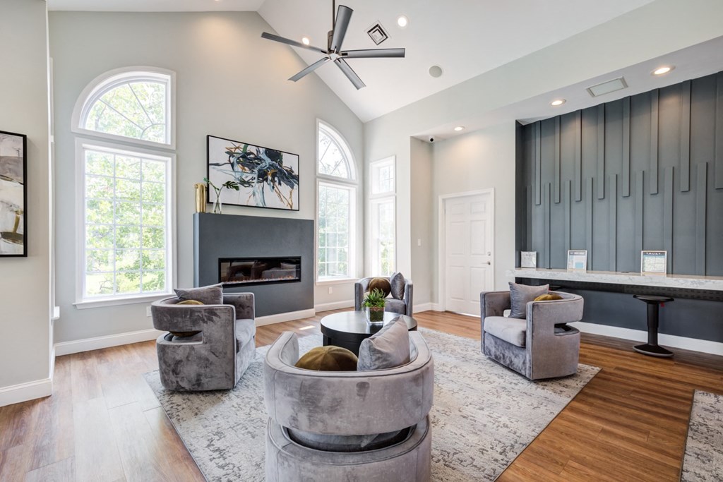 leasing center with couches and chairs and a fireplace