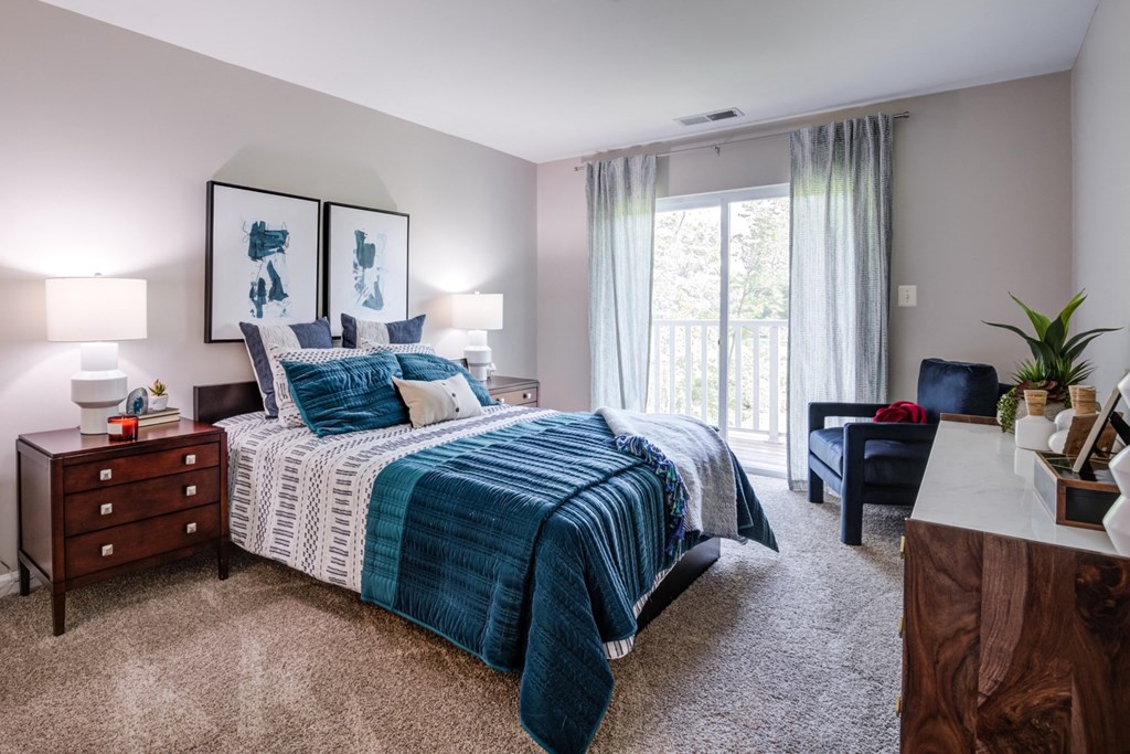 an open bedroom with a bed and a window