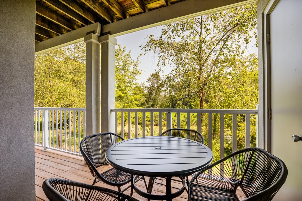 a patio with a table and chairs on a porch
