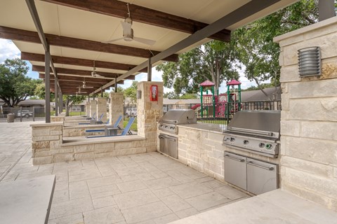 a bbq area and the apartment complex swimming pool area