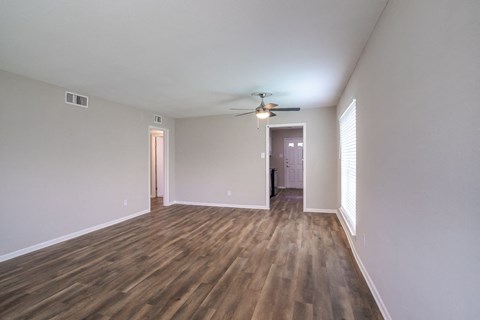 empty living room with darker wood-style flooring