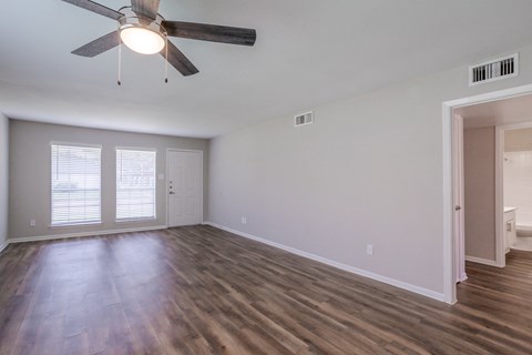 empty living room with darker wood-style flooring