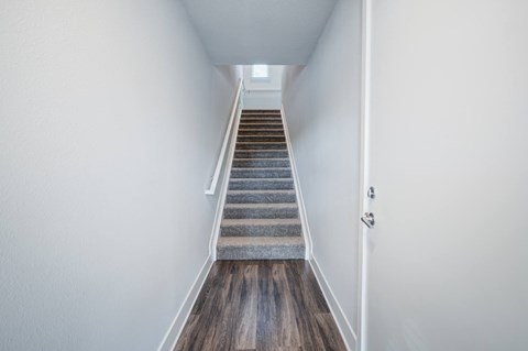 Entry way of apartment with stairs to second level