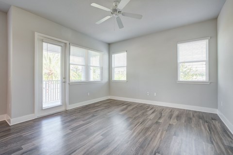 Living room with hardwood style floors and ceiling fan