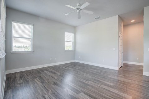 Living room with hardwood style floors and ceiling fan