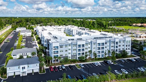 Aerial view of apartment building and parking lot