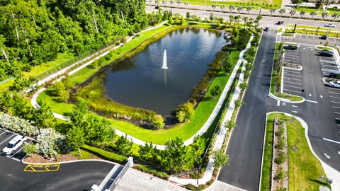 Apartment parking lot with a pond