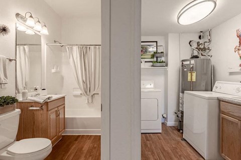 a white bathroom with a toilet and a sink