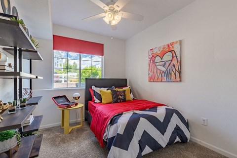 a bedroom with a bed and a ceiling fan