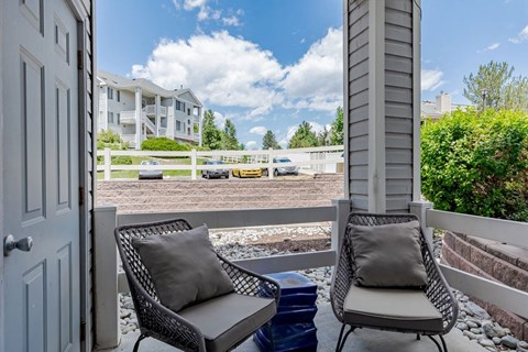 a balcony or terrace with two chairs and a table