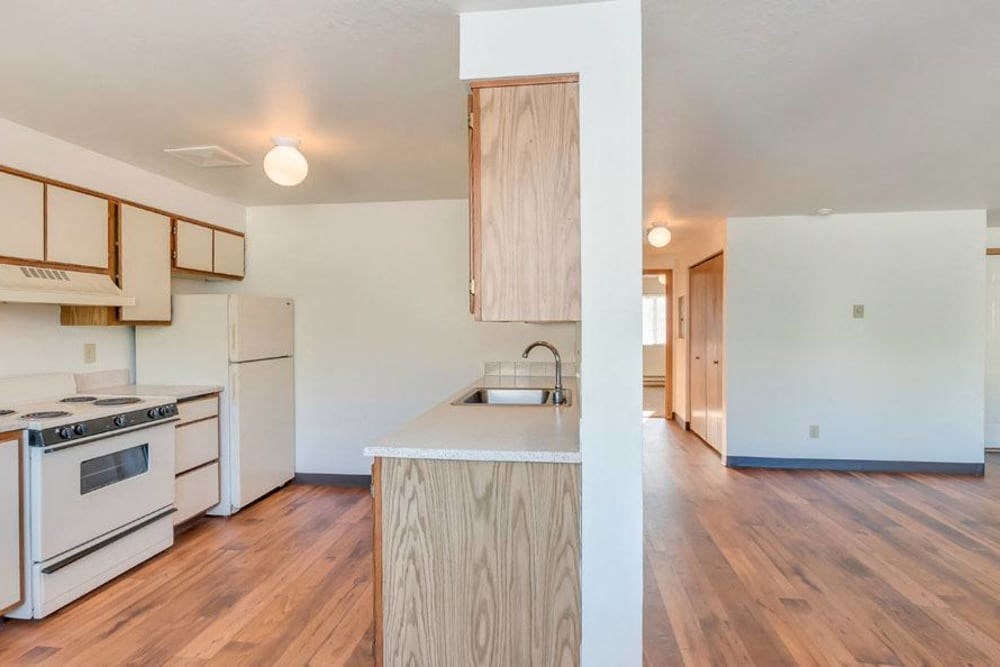 a kitchen with an island and a stove and a refrigerator