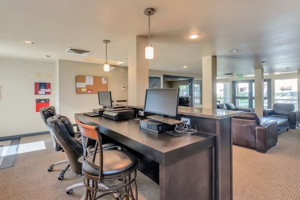 a large desk with chairs and a computer on it