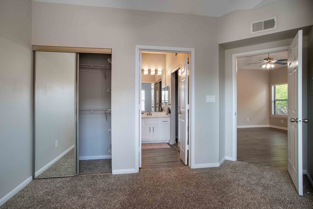 a view of a hallway with a closet and a sink