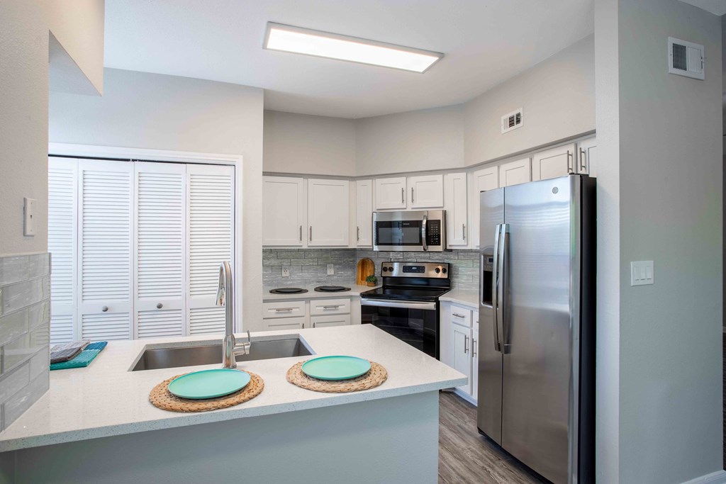 a kitchen with stainless steel appliances and a counter top