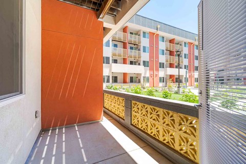 A building with orange and white balconies.