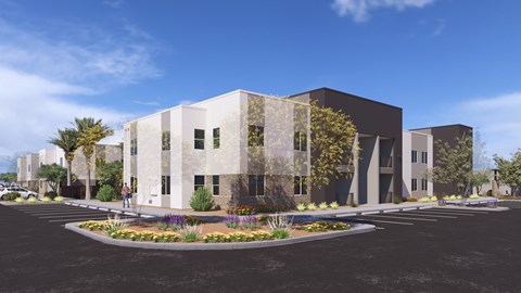 A modern building with a glass facade and a landscaped front yard.