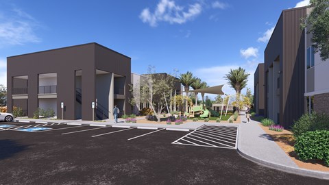 A modern building with a parking lot in front.