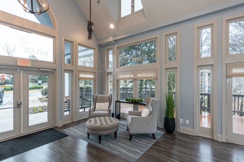 A living room with a chair and a cushion on the floor.