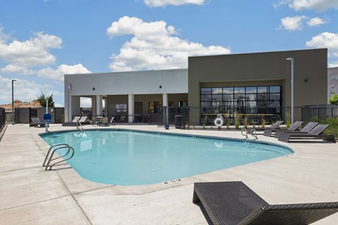 A large swimming pool in front of the clubhouse.