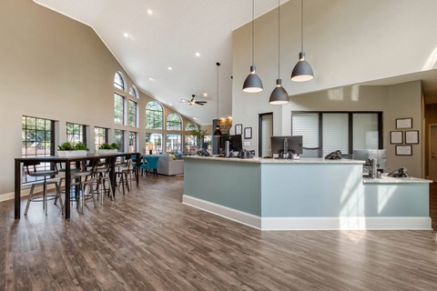 A reception area with a counter and chairs.