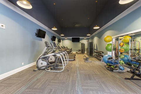 A gym with a variety of exercise equipment.