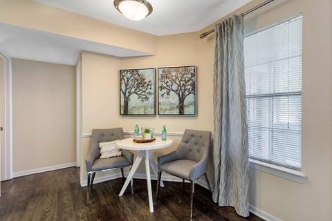 A living room with a grey chair and a white table.