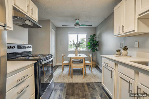 A kitchen with a table and chairs in the middle of it.