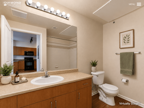 A bathroom with a sink, toilet, and a mirror.