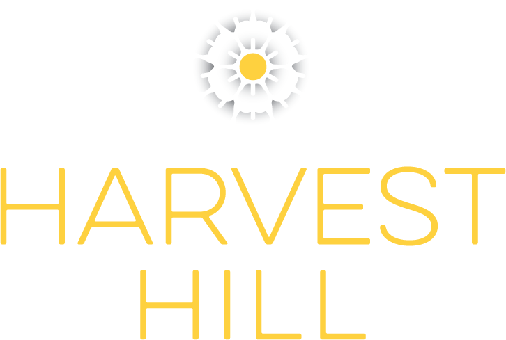 A logo with a flower and the words "Harvest Hill" in gold.