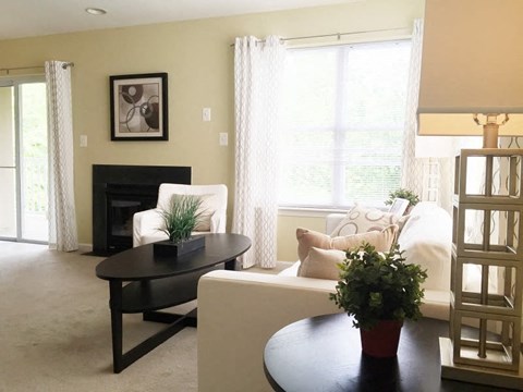 a living room with a white couch and a table