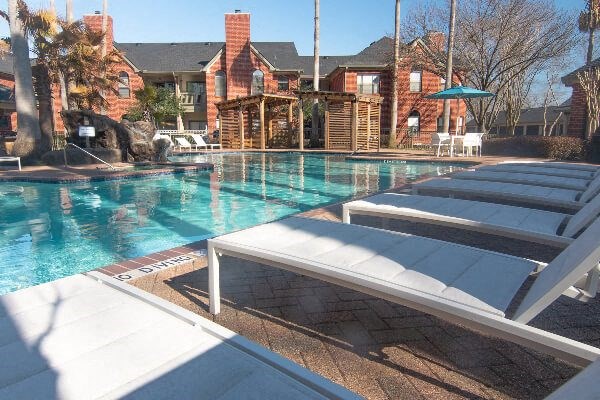 a swimming pool with a row of chairs