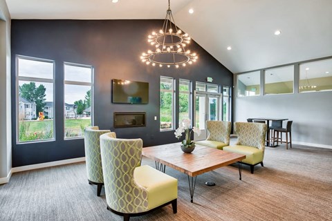 a living room with a table and chairs