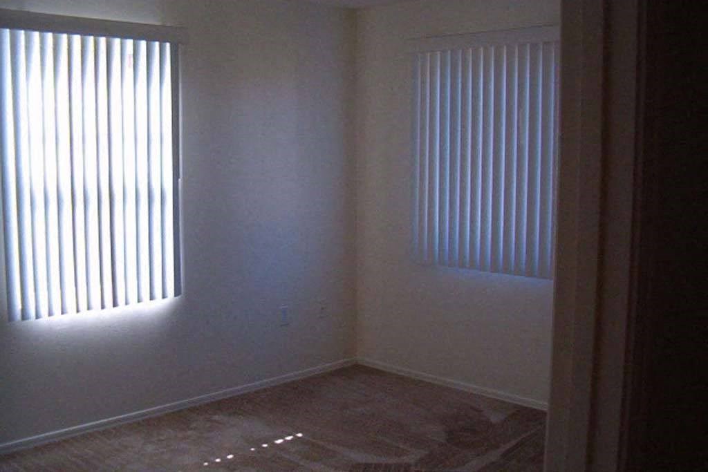 Apartment bedroom with two windows